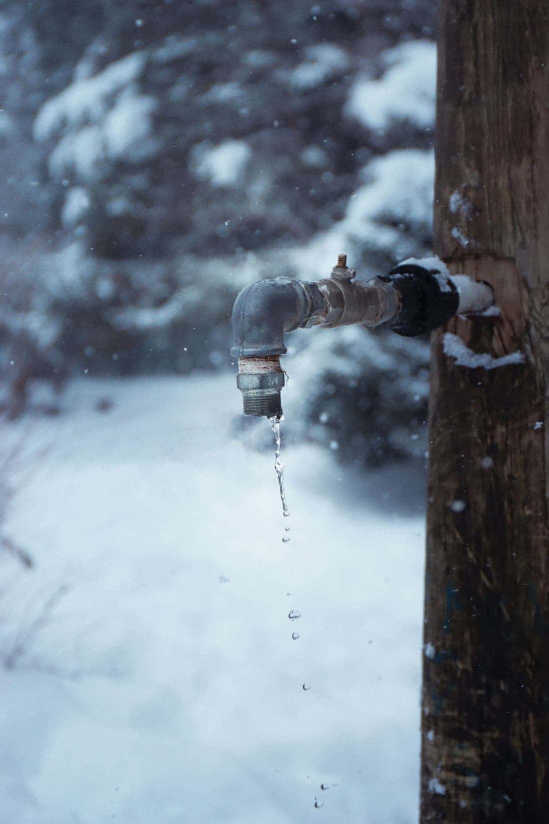 Frozen outdoor faucet with icicles