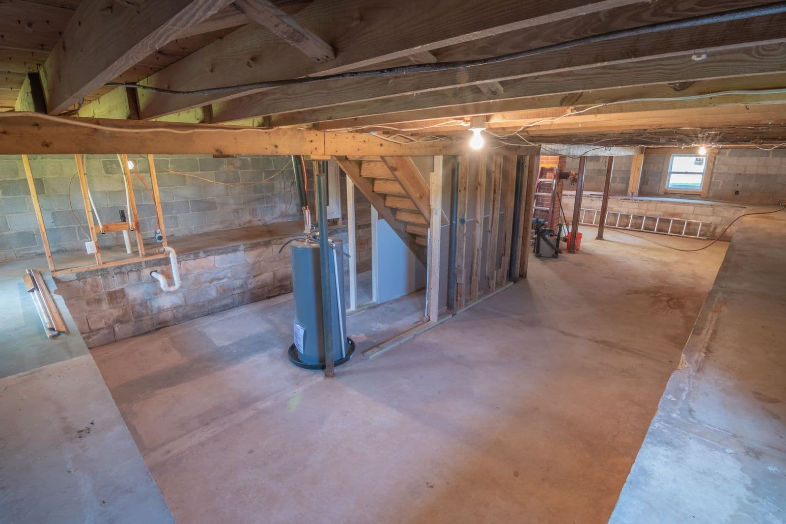 Tank water heater and utility piping in an unfinished basement
