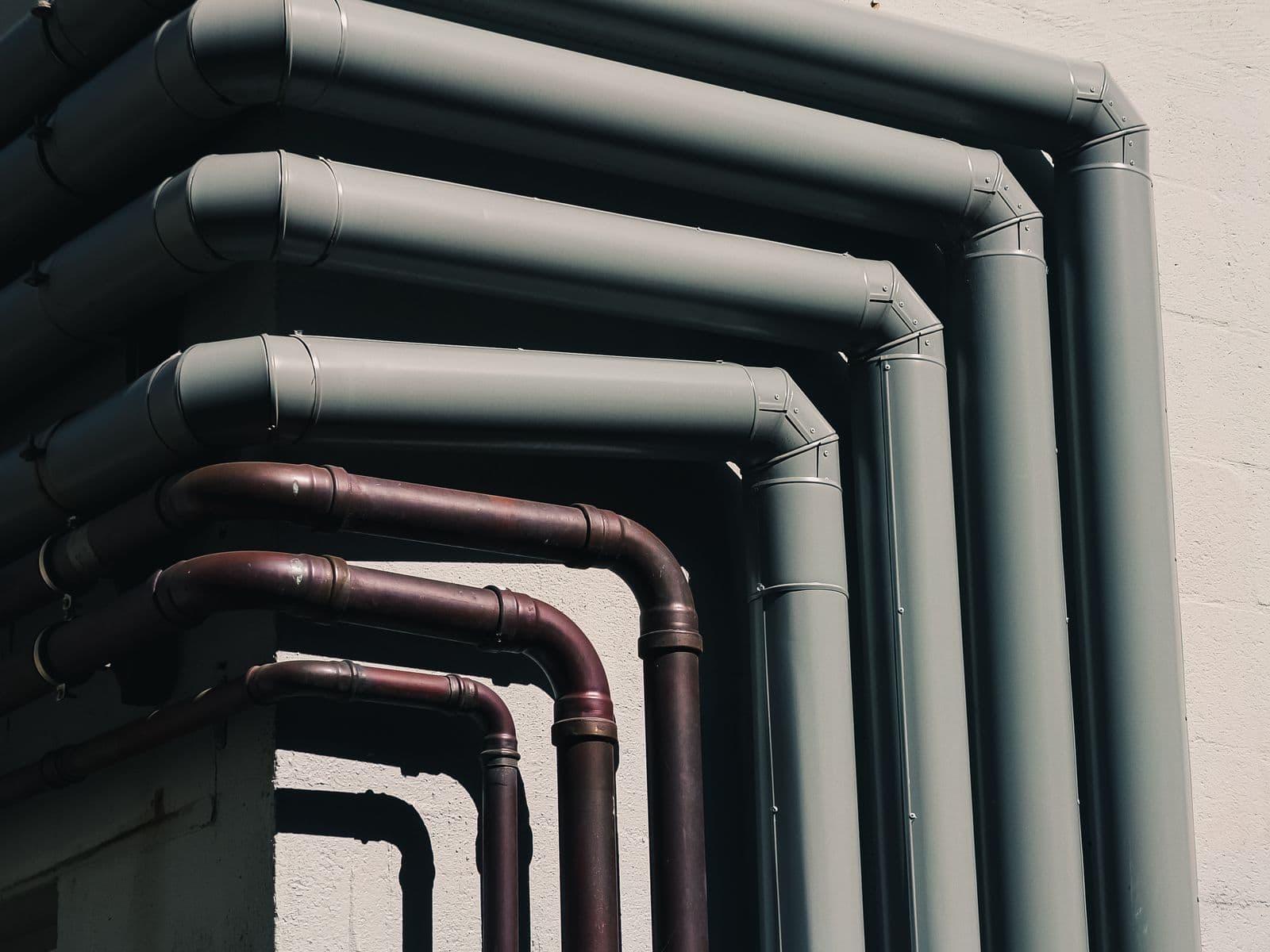 Runs of copper and insulated pipe along a wall